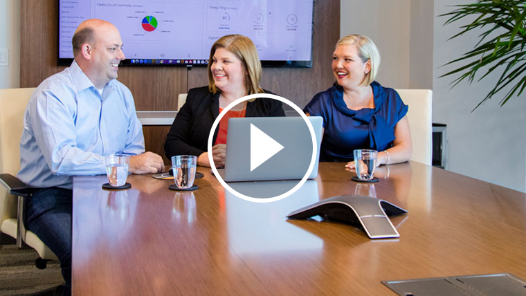 Office workers at a conference table using AxxessDDE