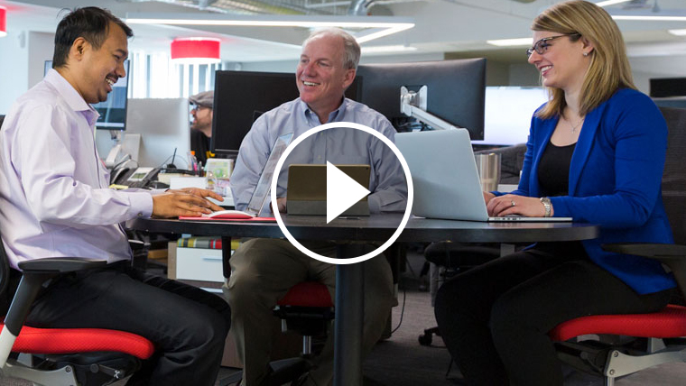 A billing team having a discussion at a table.