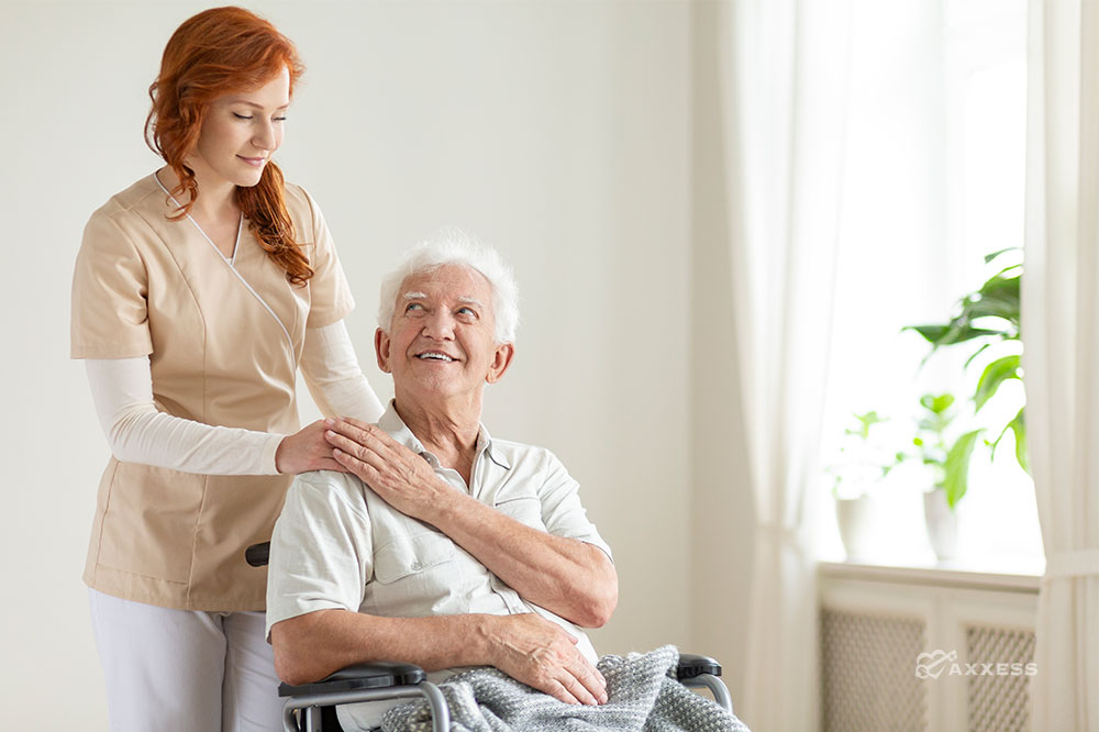 clinician comforting patient in wheelchair