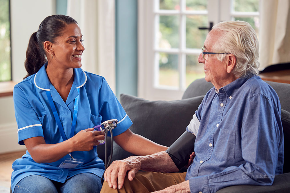Female clinician takes blood pressure of elderly male patient
