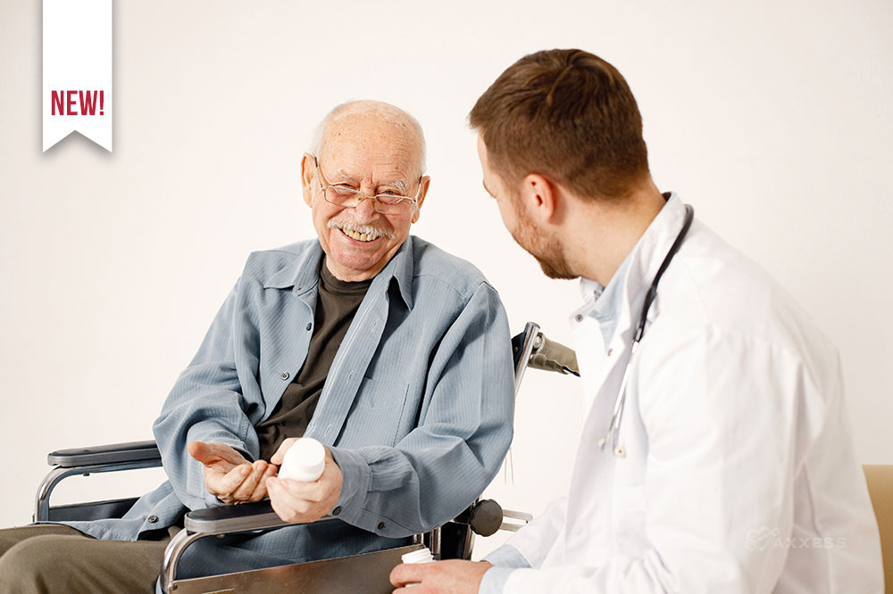 An older man holding a medicine bottle sitting with a nurse practitioner discussing medication